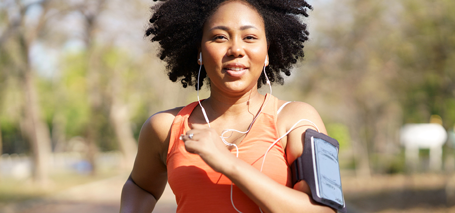Young woman running exercise wearing heartbeat monitoring and smart watch.