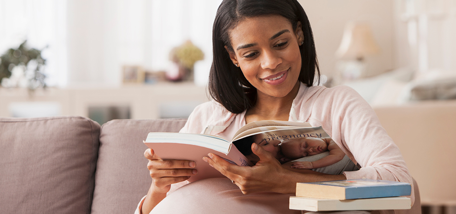Pregnant woman sitting reading a book
