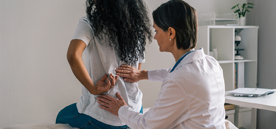 patient facing away from provider complaining about back pain in clinical office