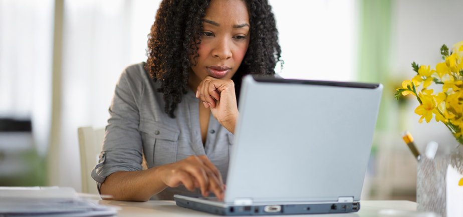 Mixed race woman using laptop