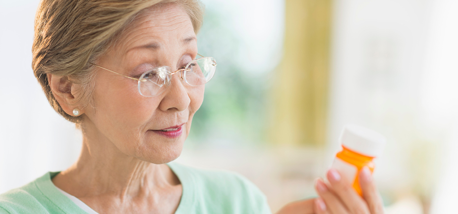 Senior woman reading medicine label