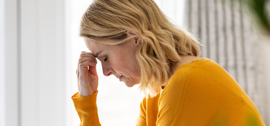 Depressed mature woman sitting at home