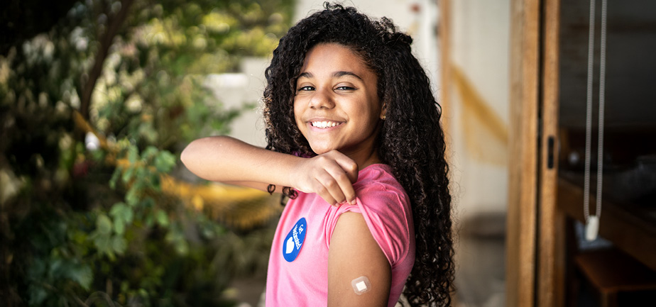 Portrait of girl showing arm after vaccination