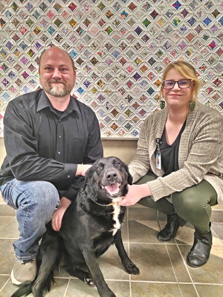 Grant Cassavant, his dog, Ember, and Brittni Abbett