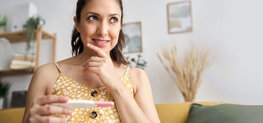 A woman holding a pregnancy test