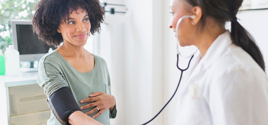 A doctor examining a pregnant woman