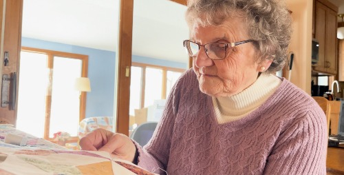 older white woman quilting