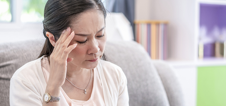 woman touching their forehead