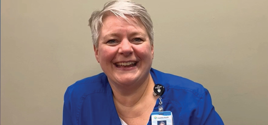 middle aged female nurse smiling at camera