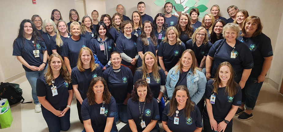 Large group of nurses gathered for a photo inside.