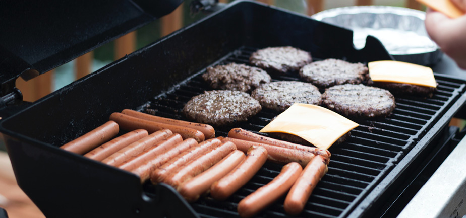 grill with burgers and hotdogs