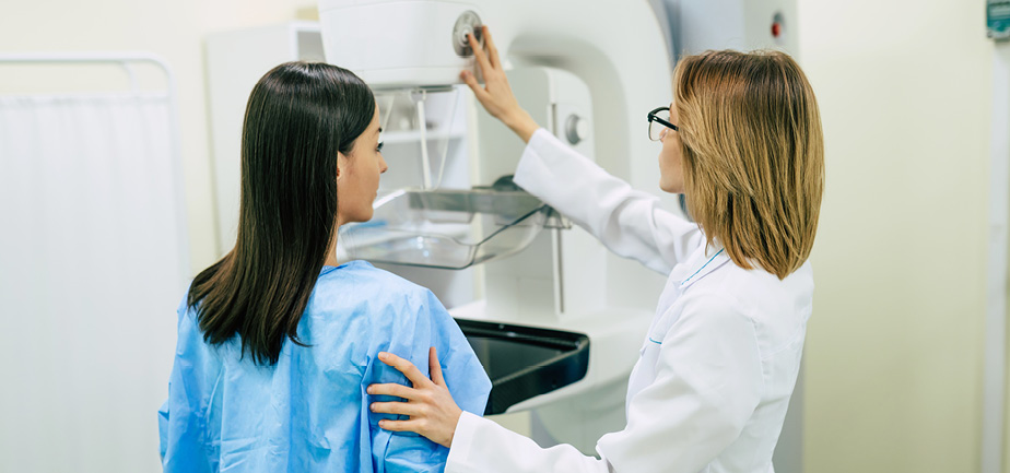 woman undergoing mammogram with female provider