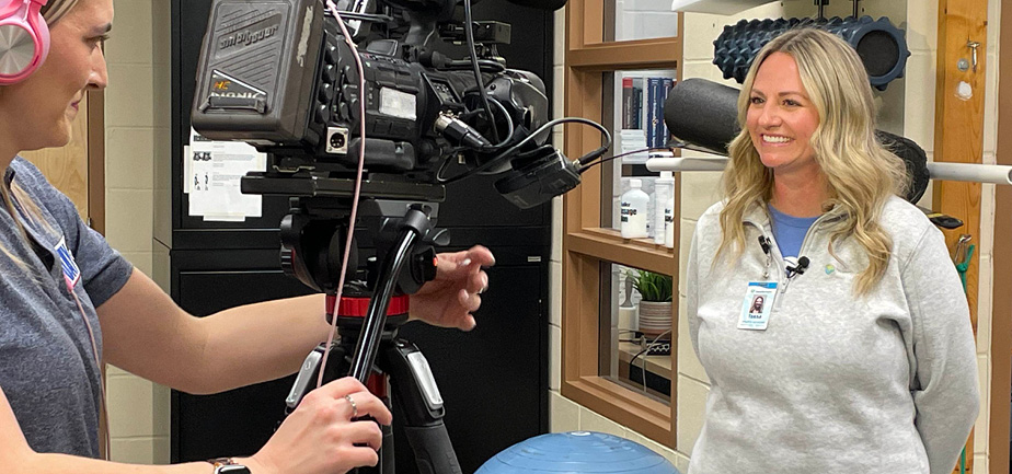 woman smiling at reporter and camera