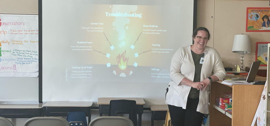 woman standing in front of projector