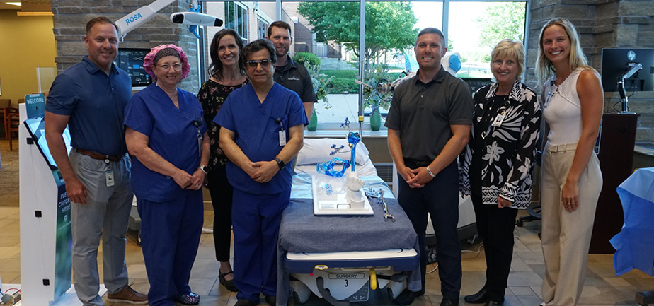 group of people standing by a piece of medical equipment