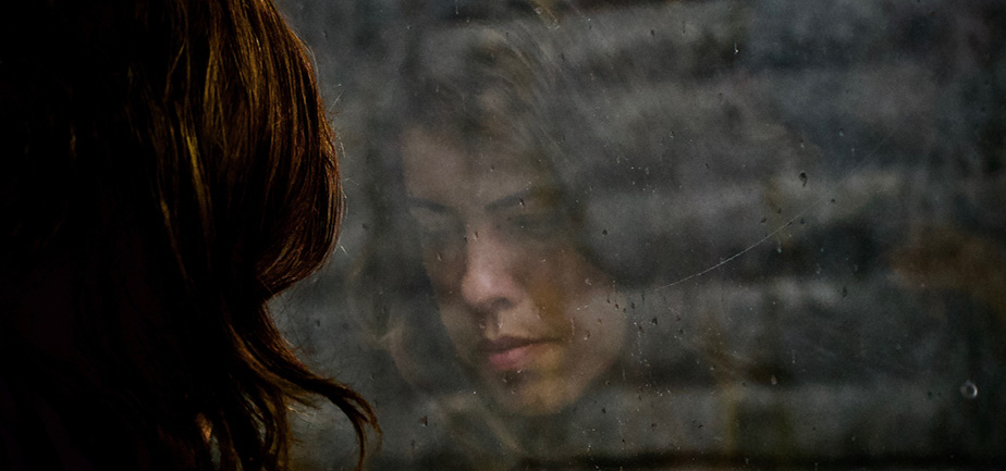 woman looking out window