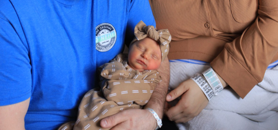 Parents holding newborn baby