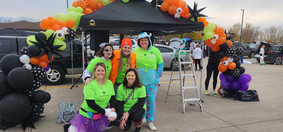 group of five people in costumes standing outside