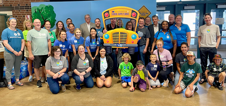 large group photo in front of a school themed backdrop