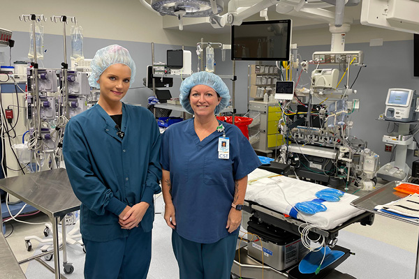 two women in scrubs inside an OR