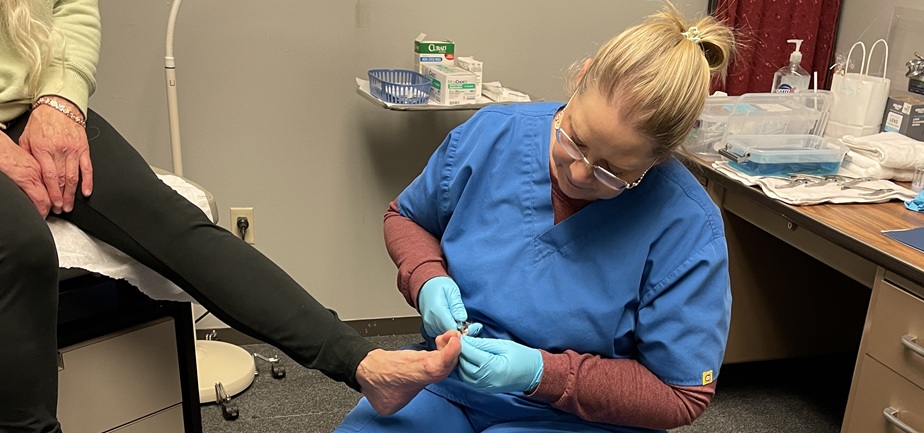 Essentia Health registered nurse Kelly Nelson clips toenails