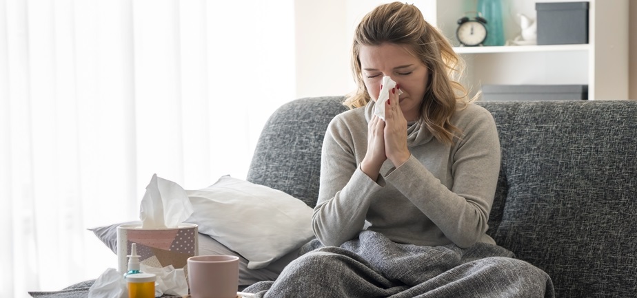Sick woman sneezing