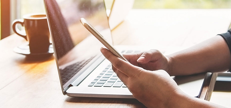 An individual checking for news and updates on a phone