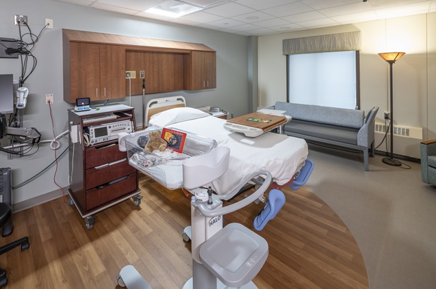 Modern hospital room with bed and medical equipment ready for patients