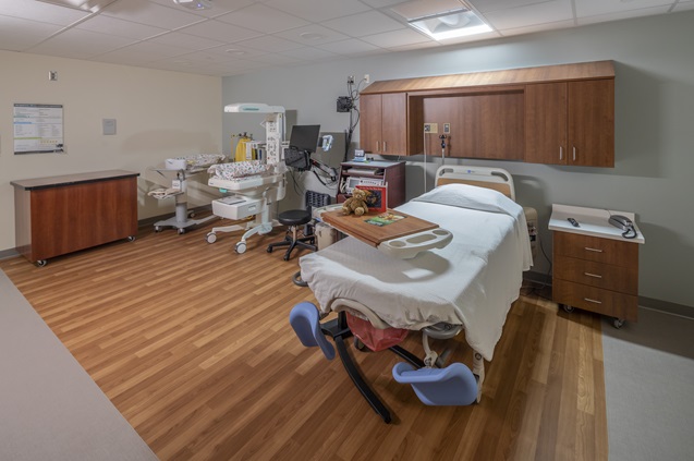 Modern hospital room with bed and medical equipment ready for patients
