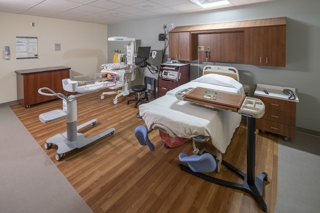 Modern hospital room with bed and medical equipment ready for patients