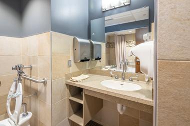 A clean bathroom sink, clean vanity top, and supplies.