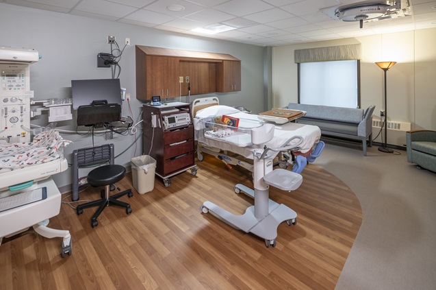 Modern hospital room with bed and medical equipment ready for patients